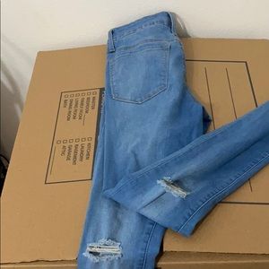 High rise jeans with distressed knee